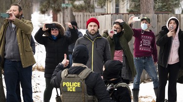 Observers film ICE agents in Minneapolis, Minn., on Feb. 5, 2026.