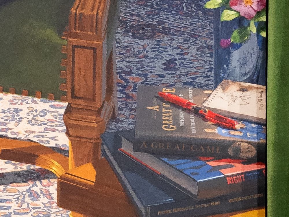  A detail of the portrait shows the books Harper has written and a sketch of a trillium signed by the artist.