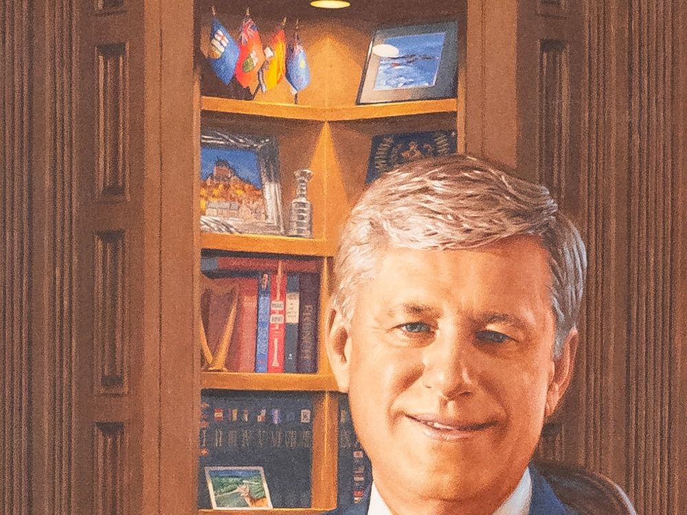  A detail of the portrait shows several of the flags and books that are meaningful to Harper, and a tiny Stanley Cup.