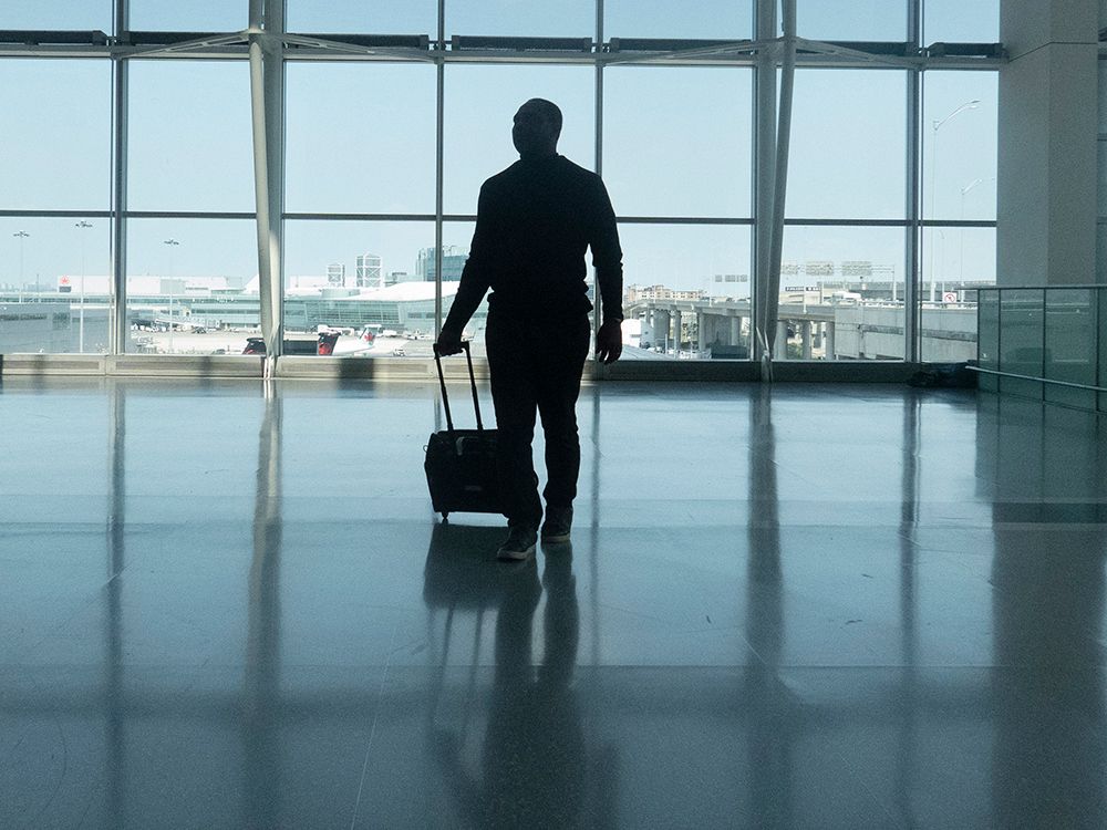 Man walking through an airport.