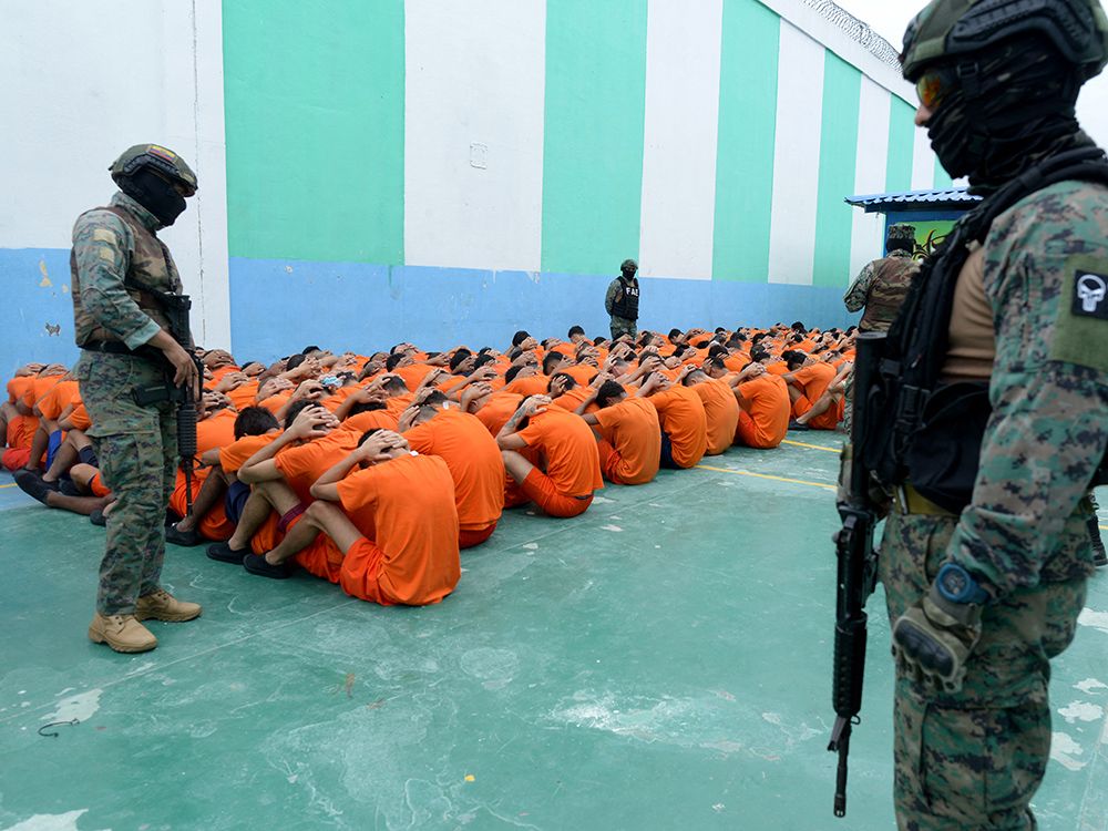 Military personnel guard inmates at a prison in Portoviejo, Ecuador, June 5, 2024. Ecuador has seen violence explode in recent years as rival gangs with links to Mexican and Colombian cartels vie for control. Military personnel guard inmates at a prison in Portoviejo, Ecuador, June 5, 2024. Ecuador has seen violence explode in recent years as rival gangs with links to Mexican and Colombian cartels vie for control.