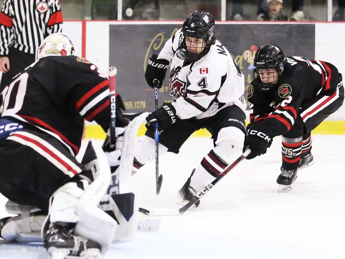  Chatham Maroons’ Brody Najim (4) shoots on Sarnia Legionnaires goalie Andrew Gaulton (30) while being chased by Michael Verberne (22) at Chatham Memorial Arena.