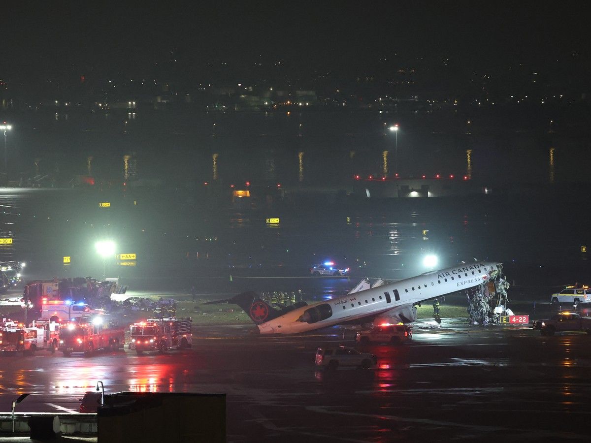  Emergency personnel respond to an Air Canada Express CRJ-900 that is sitting on the runway after colliding with a Port Authority fire truck at LaGuardia Airport in New York, on March 23, 2026.