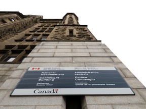 A sign on the Canada Customs and Revenue Agency (CRA) building photographed from a low angle.