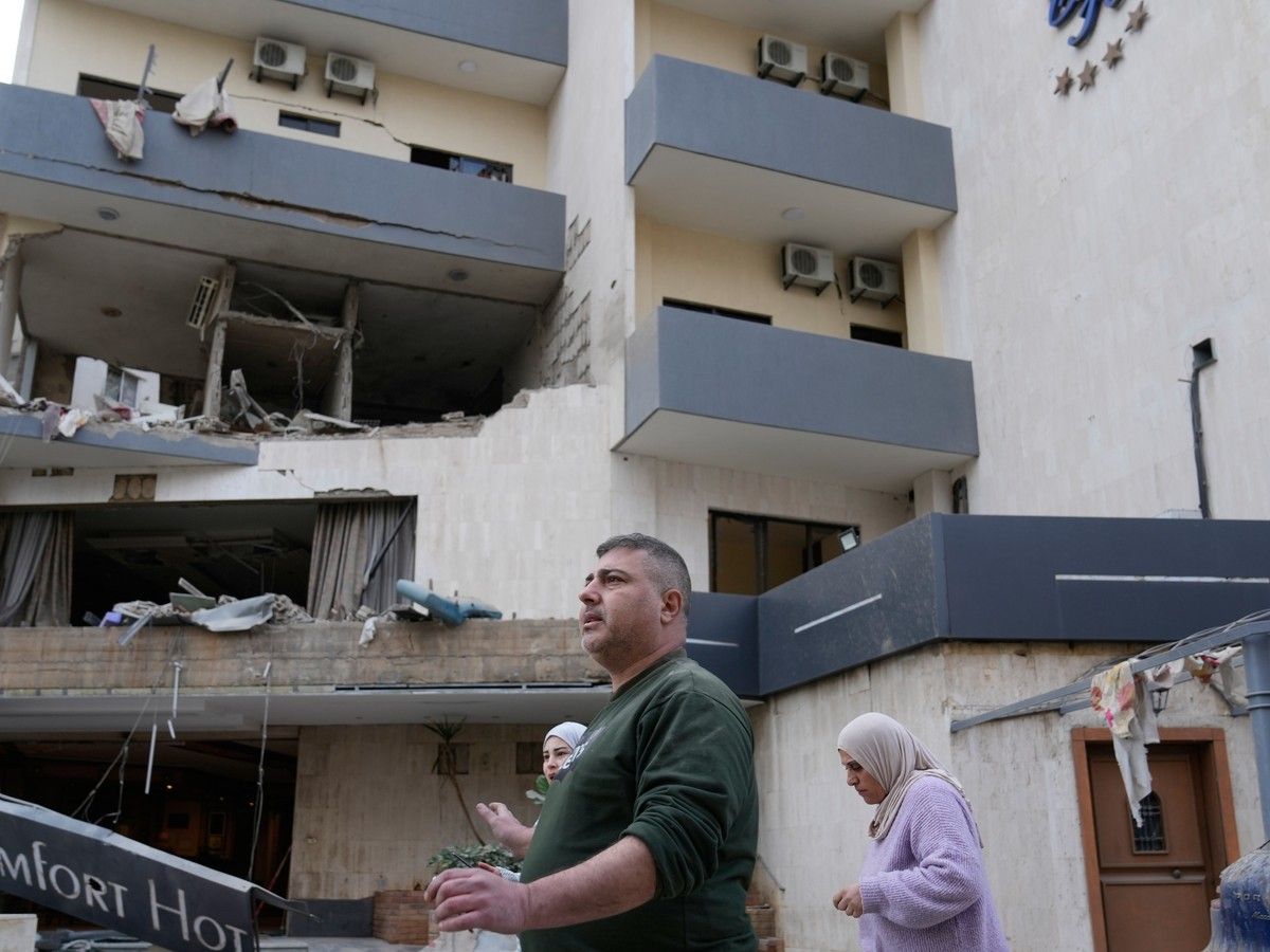 People pass in front of a damaged hotel that was hit by an Israeli airstrike in Hazmieh east of Beirut, Lebanon, Wednesday, March 4, 2026. People pass in front of a damaged hotel that was hit by an Israeli airstrike in Hazmieh east of Beirut, Lebanon, Wednesday, March 4, 2026.