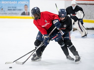 Maddox Bentley, 17, battles for the puck during training with the Yale Lions at in Abbotsford, B.C., on Tuesday, Feb. 17, 2026.