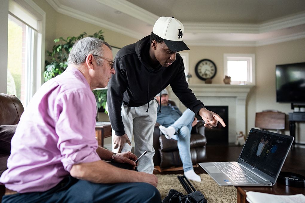Maddox Bentley looks at photos with reporter Peter Kuitenbrouwer in Abbotsford, B.C., on Tuesday, Feb. 17, 2026.