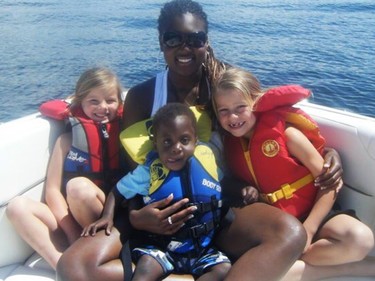 Maddox Bentley as a young child on a boat with his three sisters.