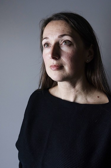 Dr. Julie Woods, who survived a vicious knife attack by her former father-in-law, poses at her home in Grimsby, Ont., on Jan. 28, 2026.