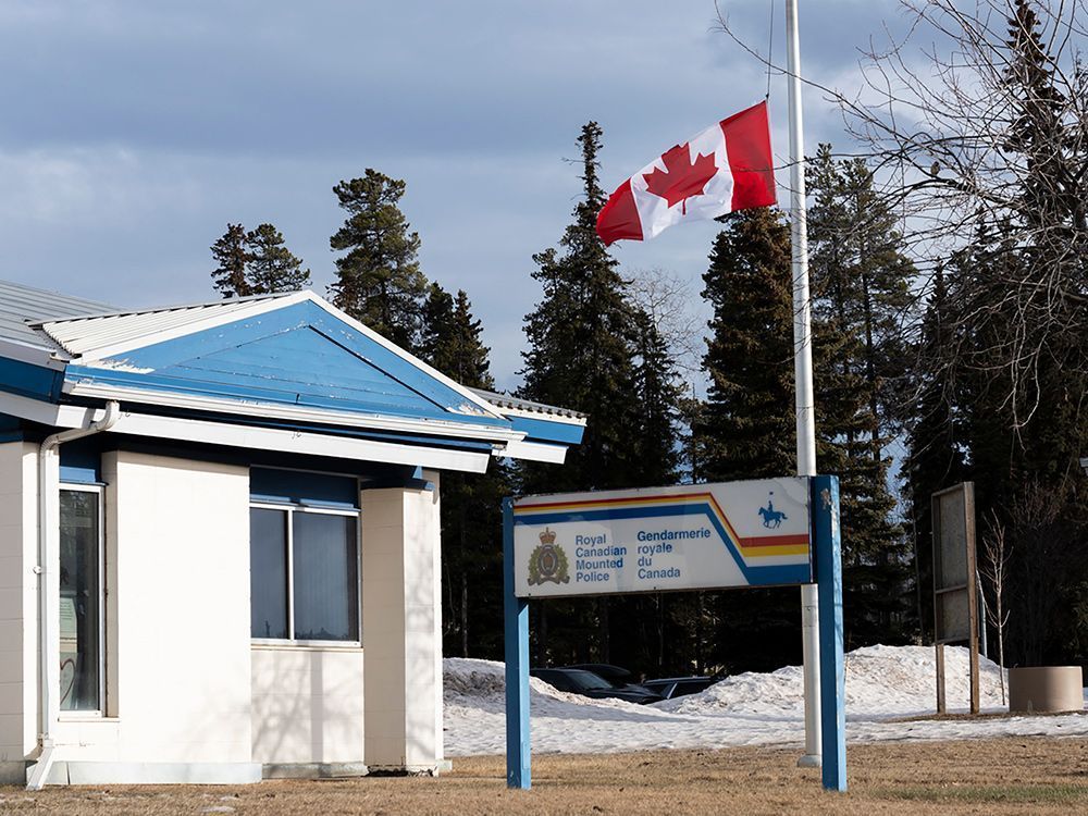 A Canadian flag flies at half-mast at the RCMP station in Tumbler Ridge, B.C., the day after a deadly mass shooting on Feb. 10, 2026.