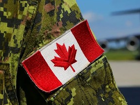 A close up of a Canadian flag patch on the arm of a Canadian Armed Forces member's uniform.