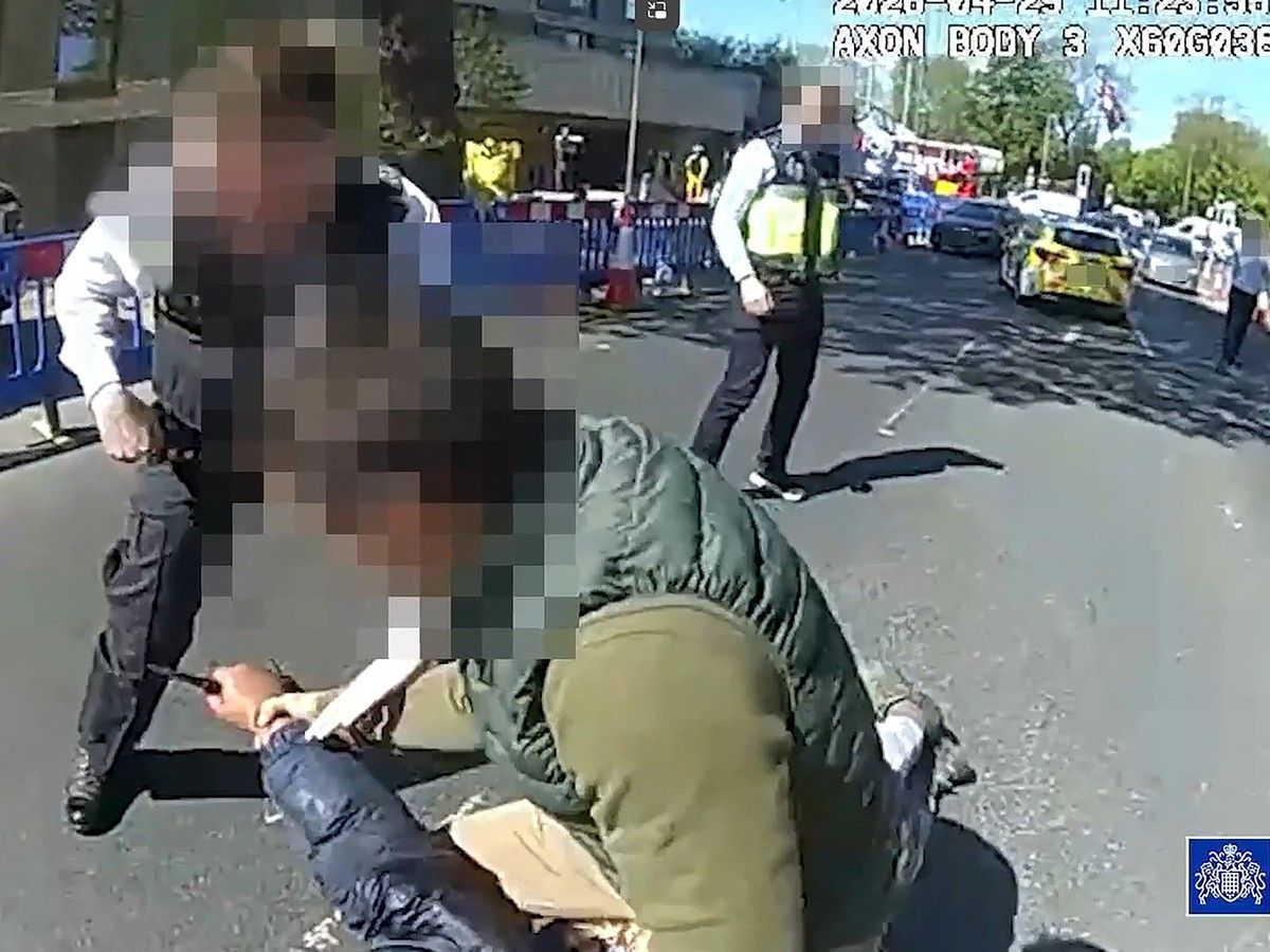  A screen grab taken from body camera video shows police trying to disarm a man holding a knife as they detain him in the Golders Green neighbourhood of London, England, after he allegedly stabbed two people nearby.