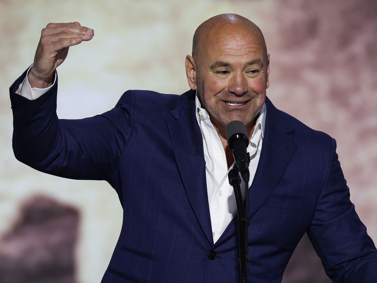 Dana White speaking on stage from behind a microphone