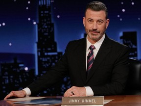 Jimmy Kimmel sat behind a desk hosting