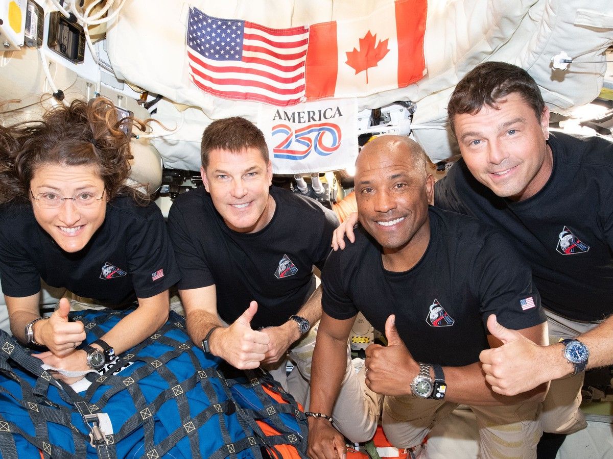  In this handout image provided by NASA, the Artemis II crew – (from left) Mission Specialist Christina Koch, Mission Specialist Jeremy Hansen, Pilot Victor Glover, and Commander Reid Wiseman – pause for a group photo inside the Orion spacecraft on their way home.