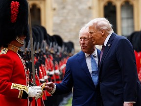 King Charles III and U.S. President Donald Trump inspect the honour guard outside Windsor Castle during Trump's state visit, Sept. 17, 2025.
