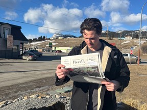 Treyton Chomyn reads the Crowsnest Pass Herald.