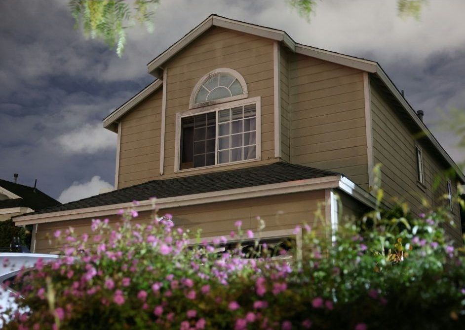 FBI agents were seen preparing to enter a gabled two-story residence in Torrance, Calif., linked to the suspect. (Patrick T. Fallon/AFP)