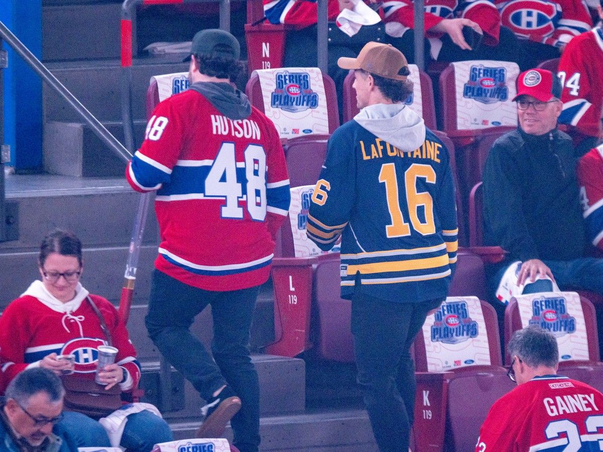  A Buffalo Sabres fan walks to his seat at the Bell Centre with a Montreal Canadiens fan prior to Game 3 in Montreal on Sunday May 10, 2026.