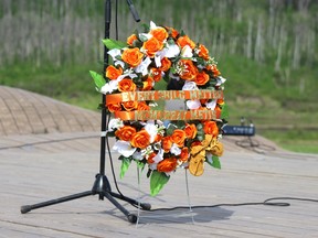 A wreath is placed on the stage at the Snye in memory of the 215 children whose bodies were found at a Kamloops residential school.