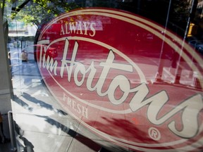 A Tim Hortons sign pictured through a shop window
