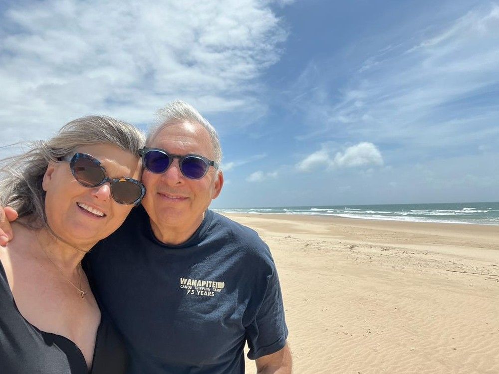 Beth and Eric Roher on a beach