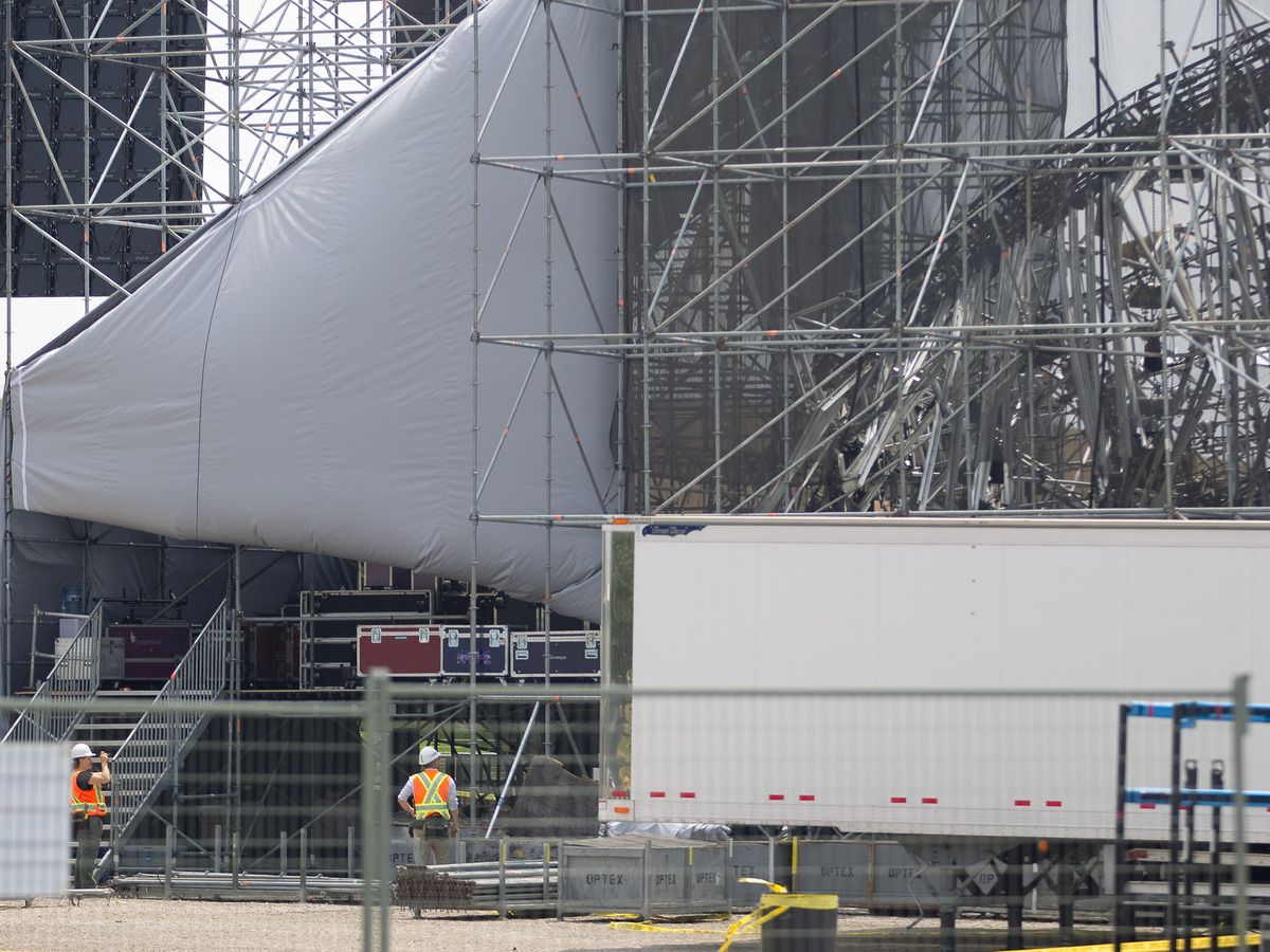  Investigators survey the scene at Downsview Park in Toronto on June 18, 2012, following Saturday’s stage collapse just before a Radiohead concert, which left one man dead and 3 others injured.