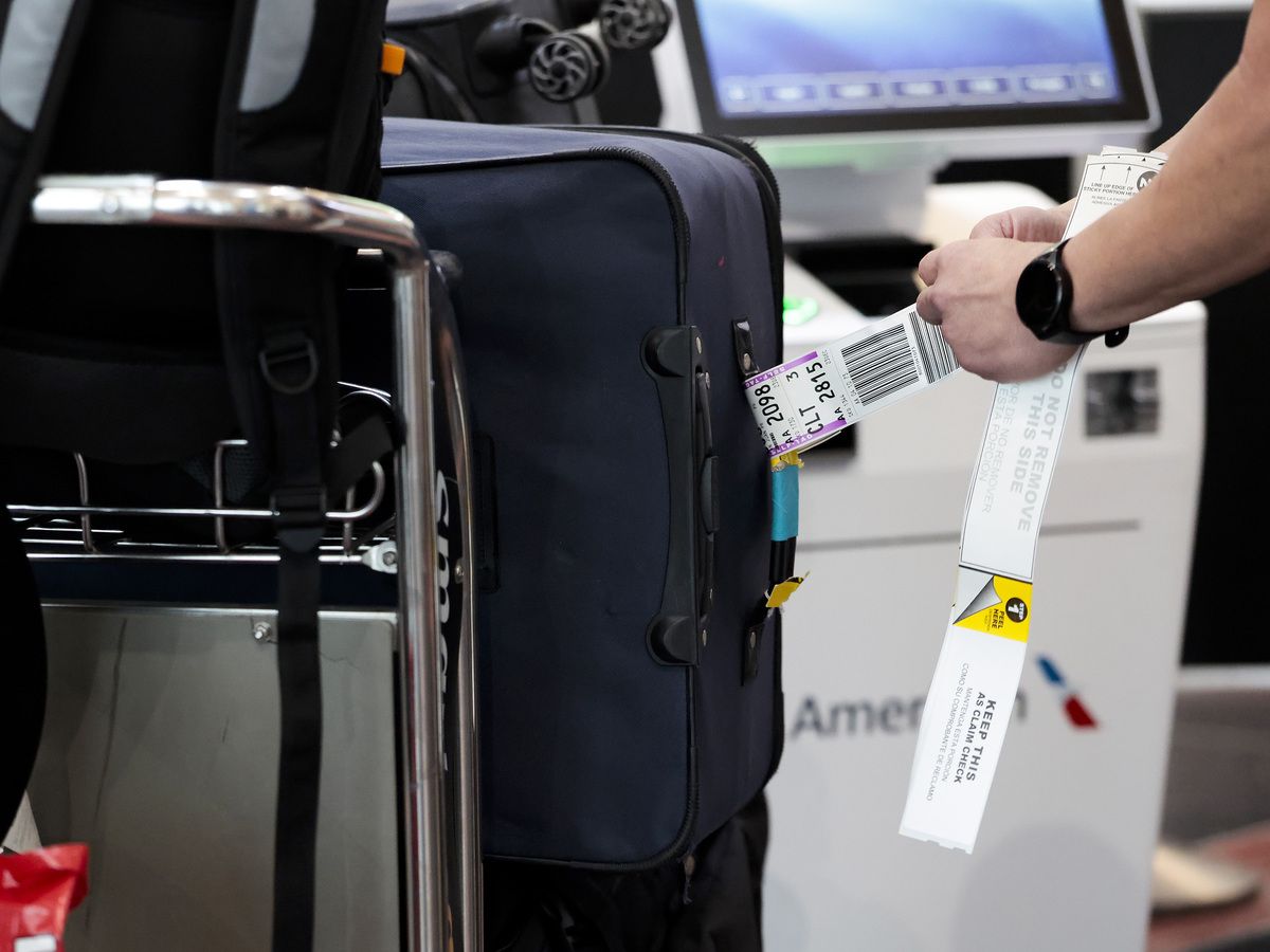 A traveller tags their bags before a flight on Dec. 23, 2025.