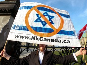 An anti-Zionist Orthodox Jew holds a sign during a protest outside of the Parliament Hill in Ottawa Tuesday Nov 16, 2010.