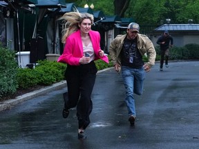 Members of the media flee
