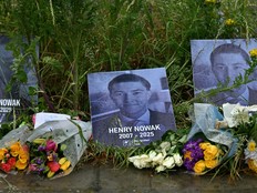 A photo of Henry Nowak with his year of birth and death next to floral tributes.