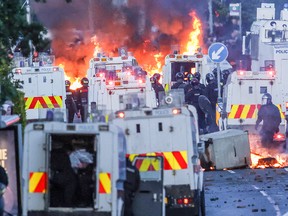 Fires, police vehicles and armoured officers.