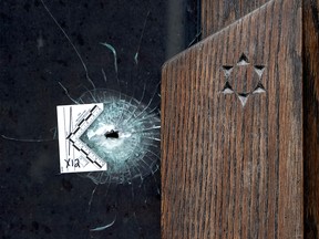 A bullet hole is seen in a front door at Temple Emanu-El in Toronto .