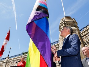 Mark Carney raising a rainbow flag.