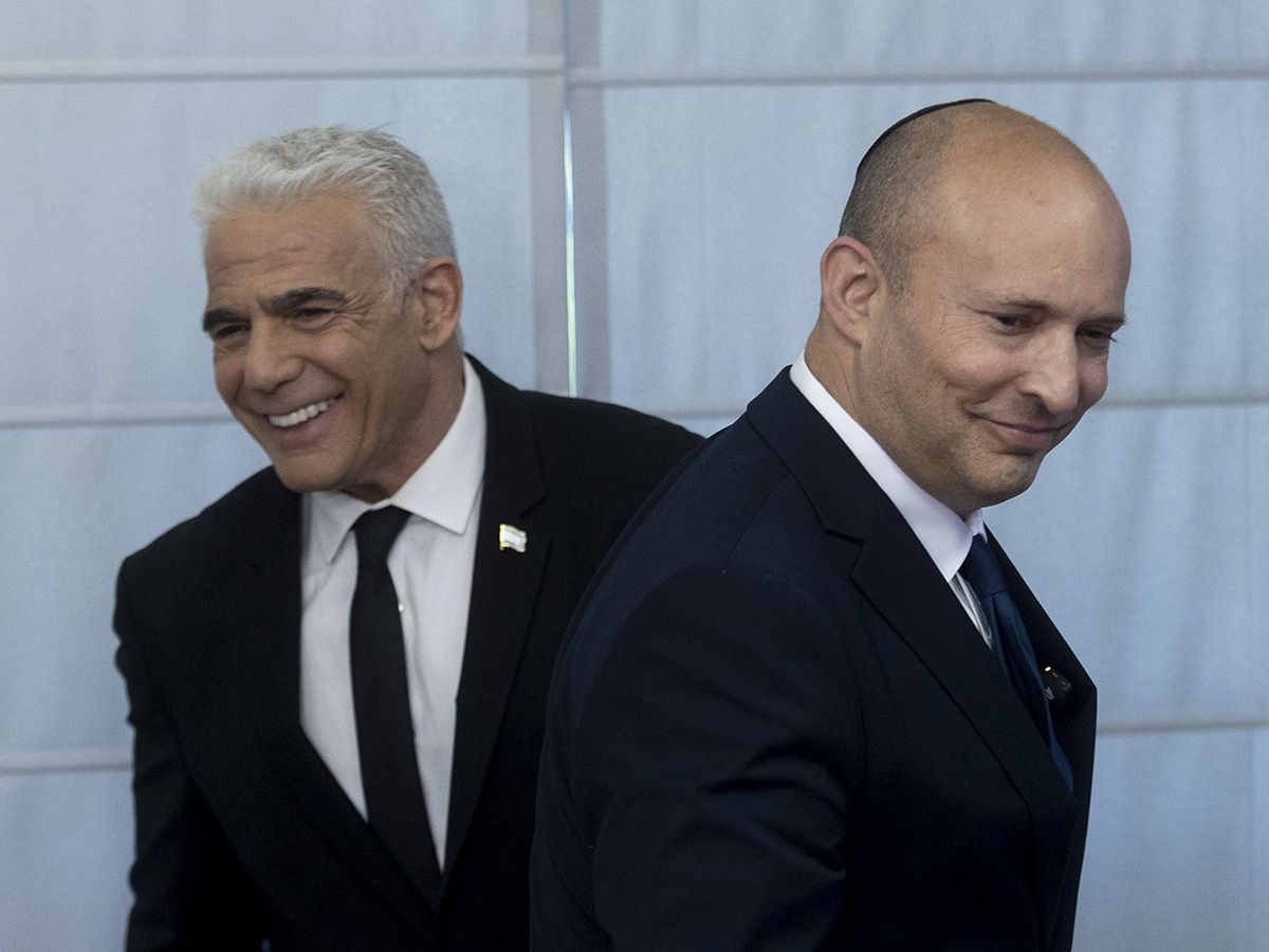  Naftali Bennet and Yair Lapid, smile during a press conference at the Israeli parliament on May 20, 2026 in Jerusalem.