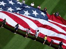 Fans roll out the American Flag on Independence Day before a game between the Minnesota Twins and the Tampa Bay Rays at Target Field on July 4, 2025 in Minneapolis, Minnesota.