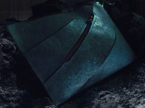 green handbag on a rock