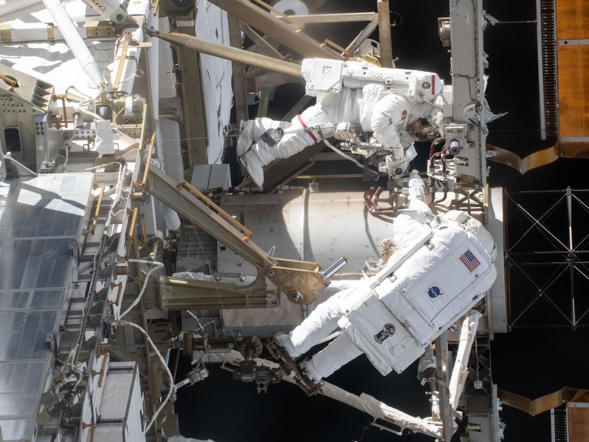  NASA astronauts Jessica Meir (top) and Chris Williams are pictured during a spacewalk on March 18, 2026, to complete the installation of a solar array modification kit on the International Space Station.