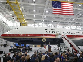 A small crowd in front of a plane.