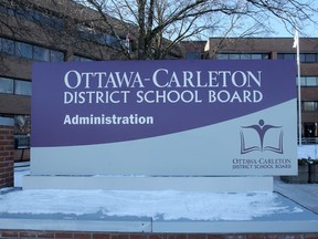 A blue and white sign reading 'Ottawa Carleton District School Board' outside a building