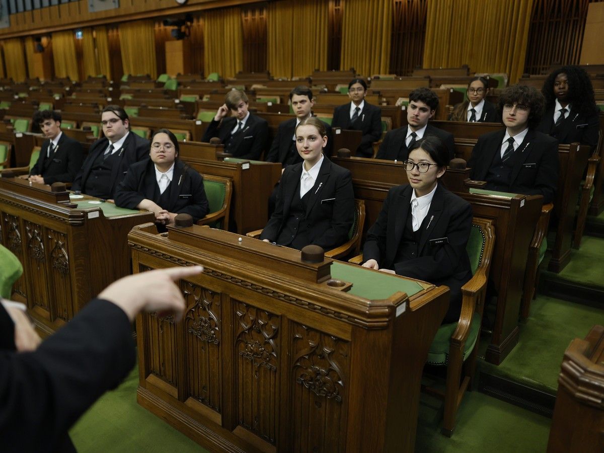 Parliamentary Pages are briefed before House business begins in the House of Commons.