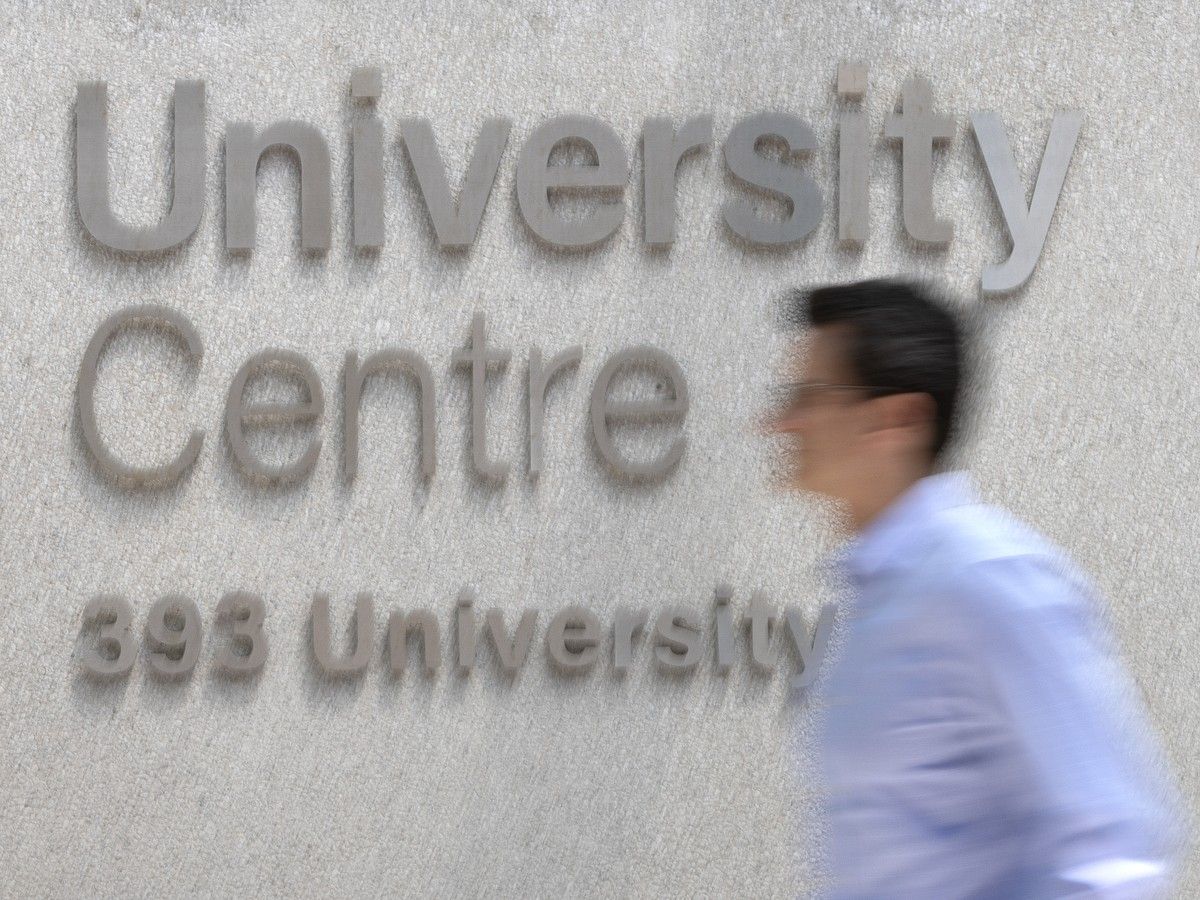 A person walking in front of the words University Centre 339 University