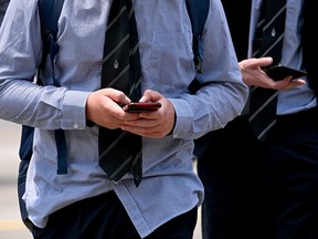 Teens looking at their phones.