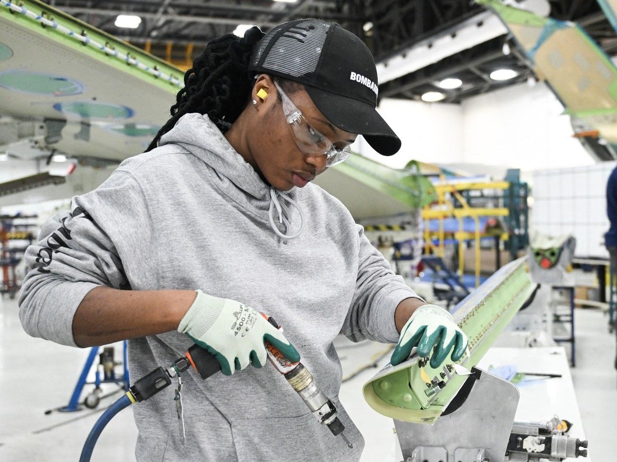 Workers assemble a Bombardier Challenger aircraft under construction at the Bombardier manufacturing facility in Montreal. Workers assemble a Bombardier Challenger aircraft under construction at the Bombardier manufacturing facility in Montreal.