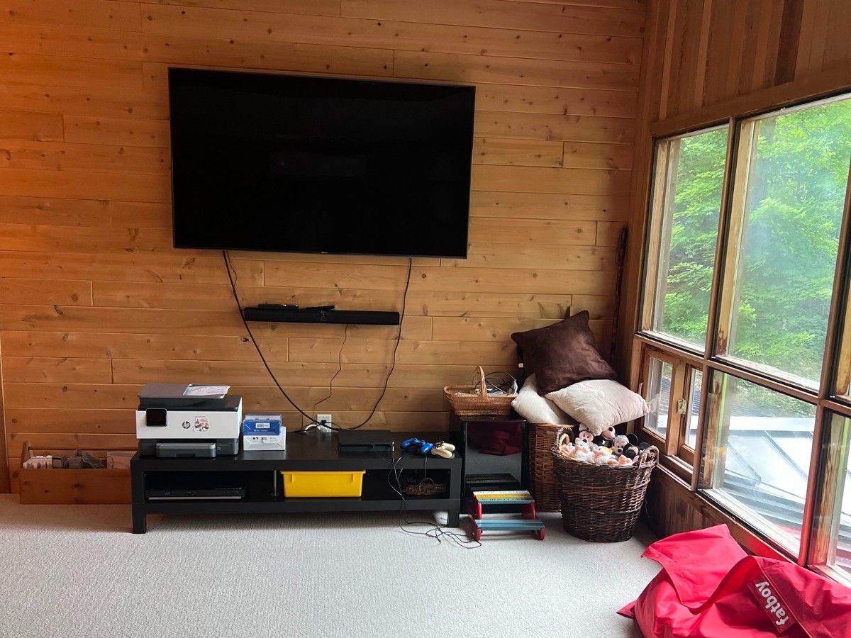 Moving the TV to the wall opposite will make use of a deeper bank of space for furniture to hold video games and cables.