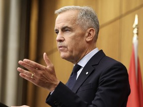 Mark Carney gesticulates while giving a speech.