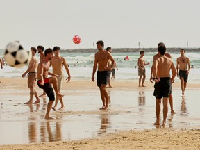 People play football on the beach in the Israeli coastal city of Tel Aviv on July 7, 2026.