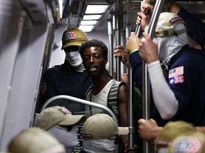 Black man surrounded by white supremacists as they ride a subway together