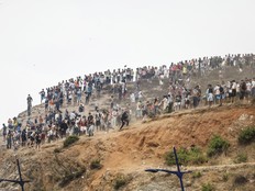 Migrants attempting to cross into Spain's North African enclave of Ceuta gather on a hilltop during clashes with Moroccan security forces near the town of Fnideq, on the Morocco-Spain border, on July 31, 2026.