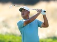 Korean Golfer watching his shot